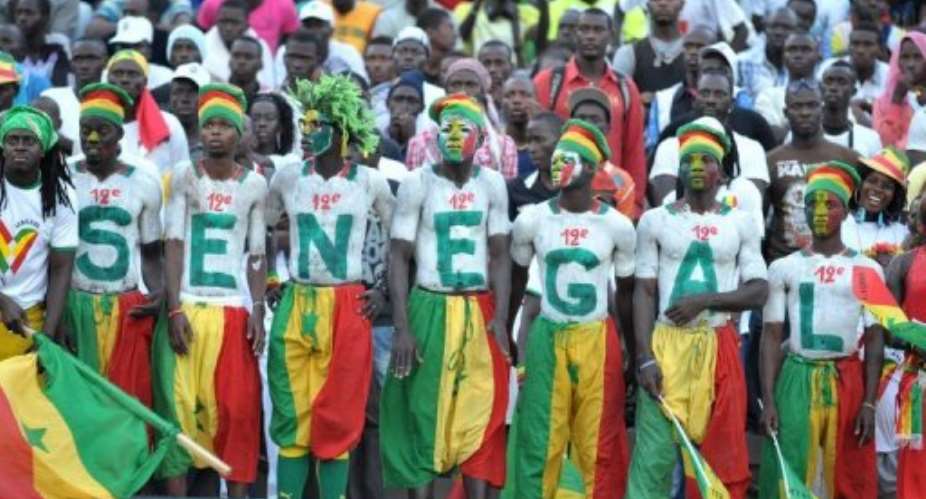 Senegalese supporters watch a football match in June.  By Seyllou (AFP/File)