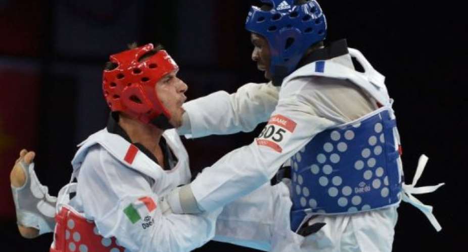 Gabons Anthony Obame (blue) fights against Italys Carlo Molfetta.  By Alberto Pizzoli (AFP)