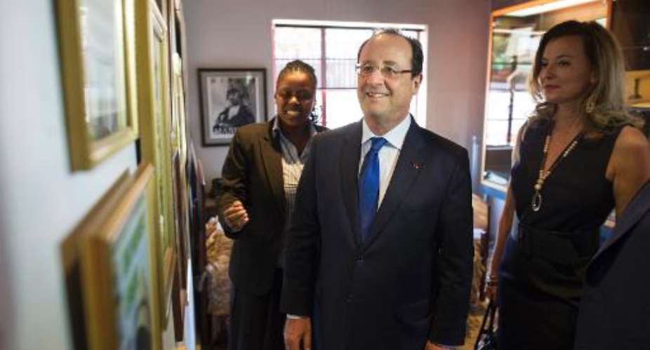 French President Franois Hollande C and his companion Valerie Trierweiler R visit Nelson Mandela's house on October 15, 2013 in Soweto.  By Fred Dufour PoolAFP