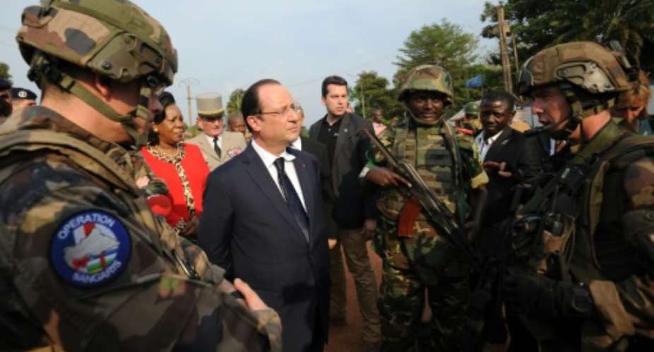 French President Francois Hollande centre met peacekeepers during a 2014 visit to the Central African Republic capital Bangui.  By Sia Kambou PoolAFP