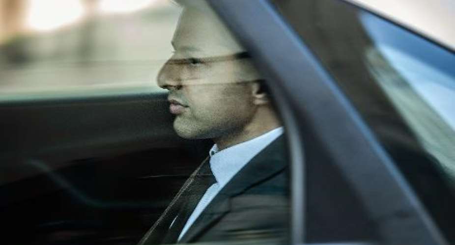 British millionaire Shrien Dewani sits in a car leaving the Cape Town High Court on October 6, 2014, after the first day of his trial for allegedly murdering his young bride.  By Mujahid Safodien AFPFile