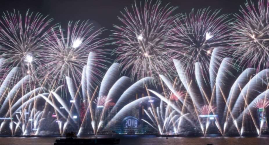 Hong Kong's famous harbour is lit up by fireworks as the city celebrates the arrival of 2018.  By DALE DE LA REY AFP