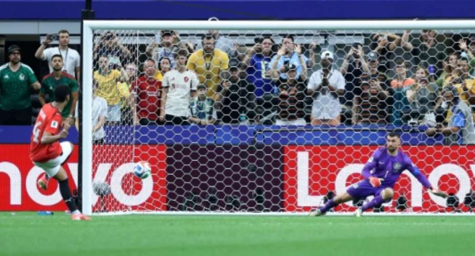 Hossam Abdelmaguid scores the winning penalty that sent Egypt into the World Cup last 16 for the first time in their history.  By Thomas COEX (AFP)