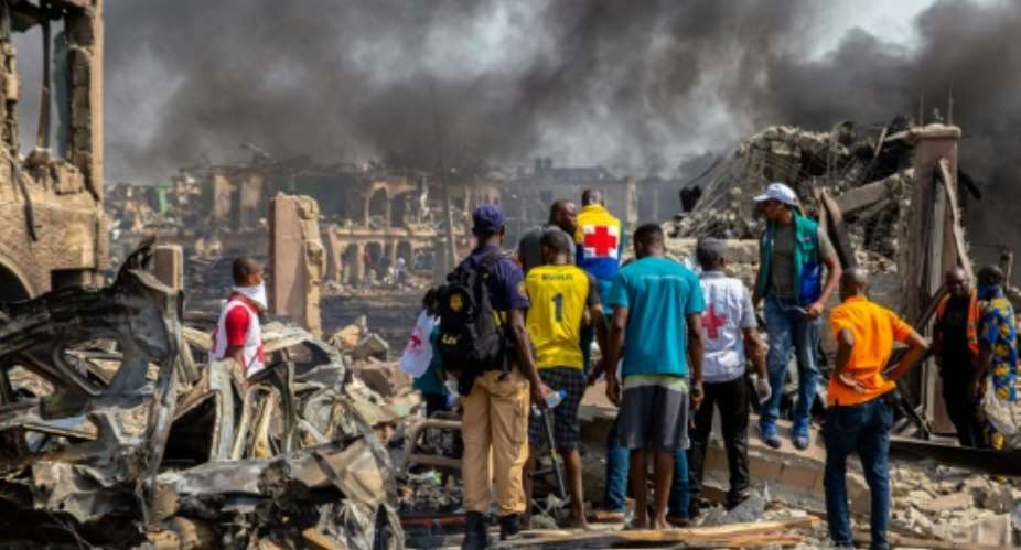 Houses, lorries, cars and motorbikes were torched in the blast.  By Benson IBEABUCHI AFP