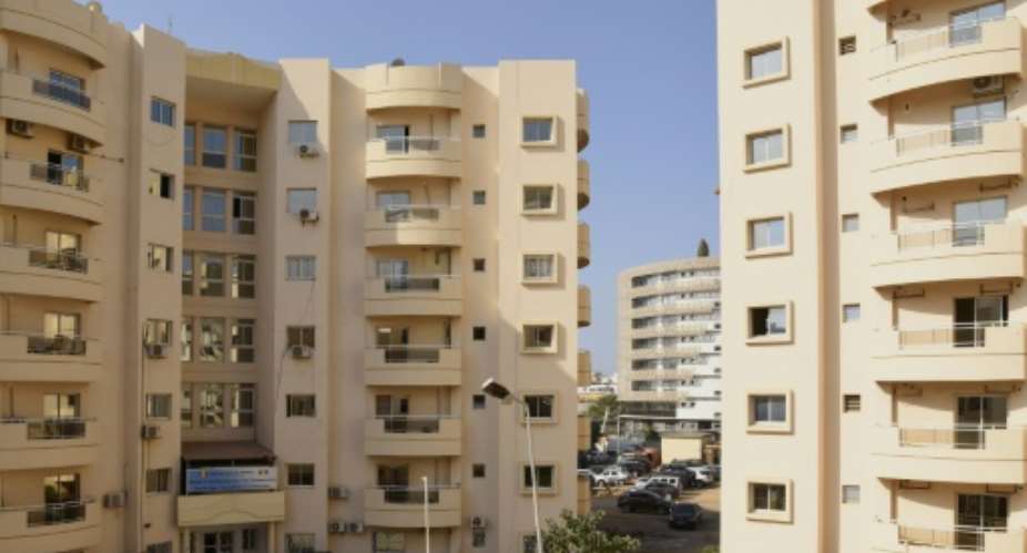 Housing boom: New apartment blocks are being built in Dakar, but spiralling rents make living there a distant dream for many.  By Seyllou AFP