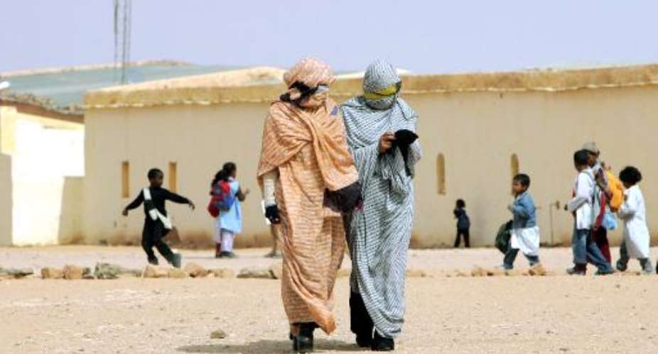 Refugees from Western Sahara walk through a school in a refugee camp in the Tindouf reigon of south-western Algeria on October 18, 2005.  By Fayez Nureldine AFPFile
