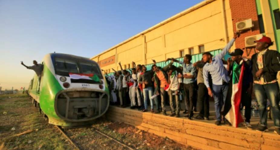Hundreds of people crammed into a train to the cradle of Sudan's uprising to mark the first anniversary of the start of the protests.  By ASHRAF SHAZLY AFP