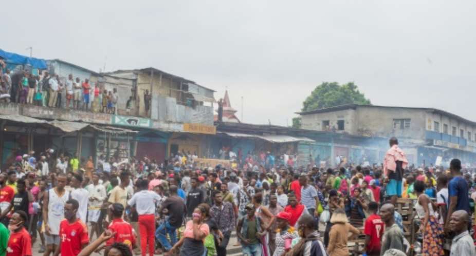 Hundreds of protesters gathered to demand the reopening of the Kinshasa market.  By ARSENE MPIANA AFP
