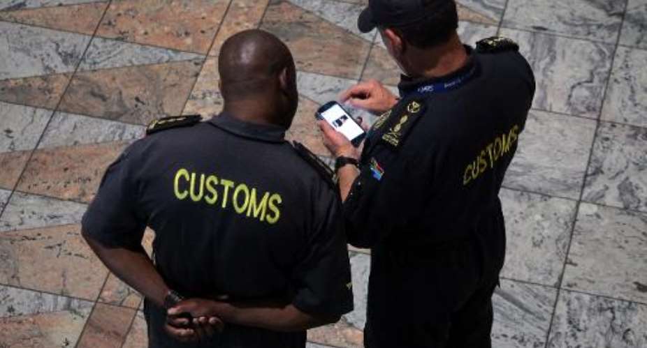Customs officials work at Tambo International Airport in Johannesburg on May 3, 2013.  By Jennifer Bruce AFPFile