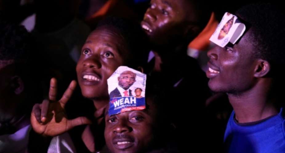 Hundreds of supporters of George Weah took to the streets of Monrovia, singing, dancing and embracing each other as news of his win in Liberia's presidential vote spread.  By SEYLLOU AFP
