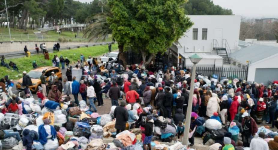 Hundreds of Zimbabweans gathered outside the Zimbabwean Consulate in Cape Town last month, seeking help to leave South Africa.  By RODGER BOSCH (AFP)