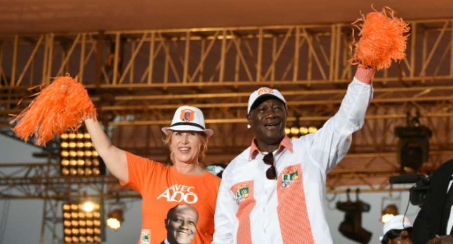 Ivory Coast President Alassan Ouattara R, accompanied by his wife Dominique Ouattara, during a campaign rally on October 23, 2015 in Abidjan.  By Sia Kambou AFP