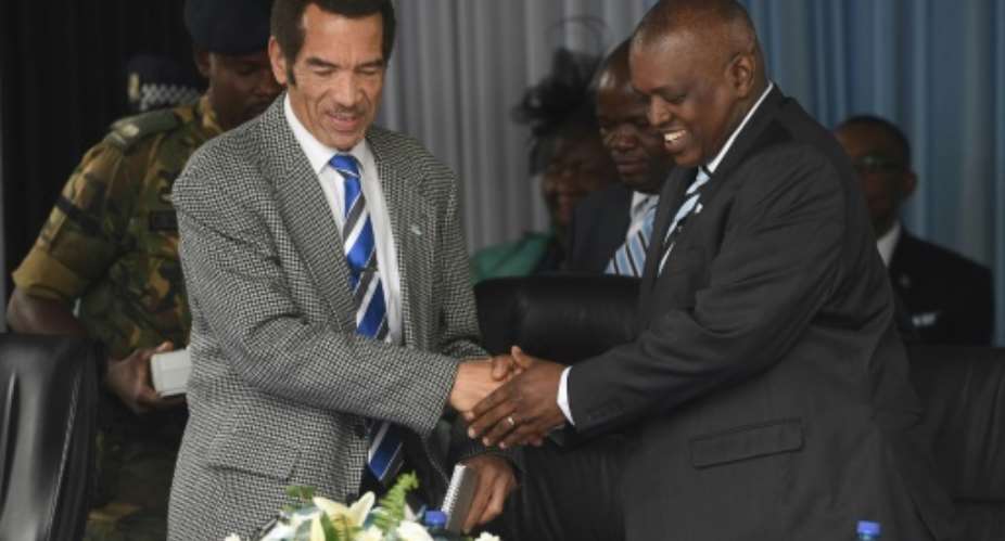 Ian Khama, left, stepped down as Botswana's president, succeeded by Mokgweetsi Masisi, right, who vowed Sunday to tackle youth unemployment.  By MONIRUL BHUIYAN AFPFile