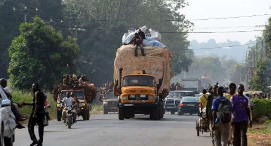A convoy of lorries and taxis packed with Muslims fleeing Christian vigilantes heads north from Bangui on February 7, 2014.  By Issouf Sanogo AFP
