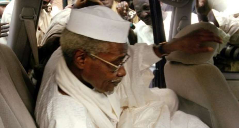 Chad's ex-dictator Hissene Habre leaves Dakar's courthouse escorted by prison guards in 2005.  By  AFPFile