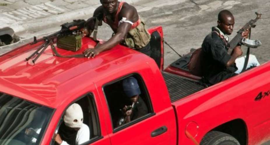 Pro-Laurent Gbagbo militiamen patrol in the empty streets of Abidjan on March 31, 2011.  By Jean-Philippe Ksiazek (AFP/File)