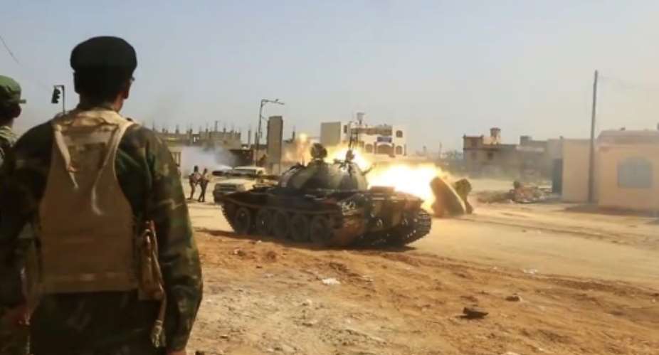 Image from a video published on the Libyan strongman Khalifa Haftar's self-proclaimed Libyan National Army War Information Division's Facebook page on April 16, 2019, shows a tank firing its turret reportedly in a southern suburb of the capital Tripoli..  By - LNA War Information DivisionAFP
