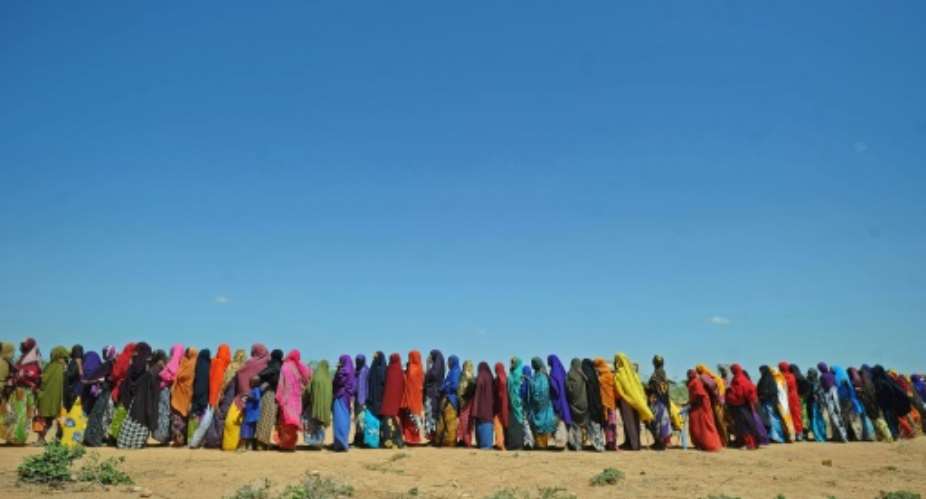 Displaced Somalis queue for aid in Beledweyne, north of Mogadishu on May 26, 2016.  By Mohamed Abdiwahab AFPFile