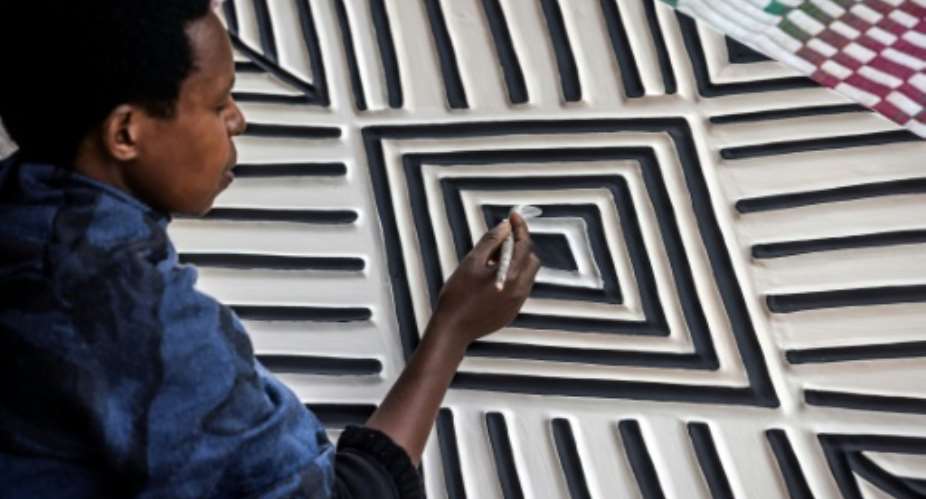 Imigongo art is known for its raised black and white patterns.  By LUIS TATO AFP