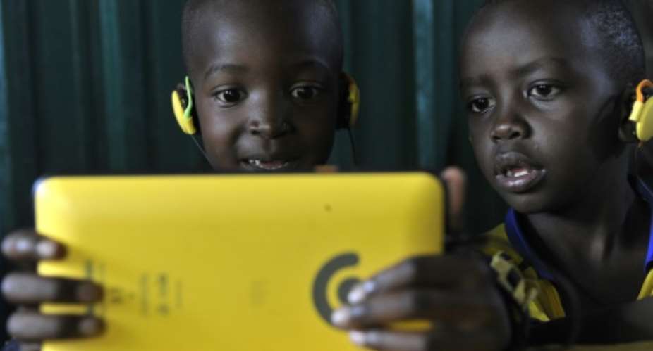 Students at Nairobi's Lighthouse Grace Academy use the Kio tablet, designed by local technology company BRCK, during class.  By Simon Maina AFP