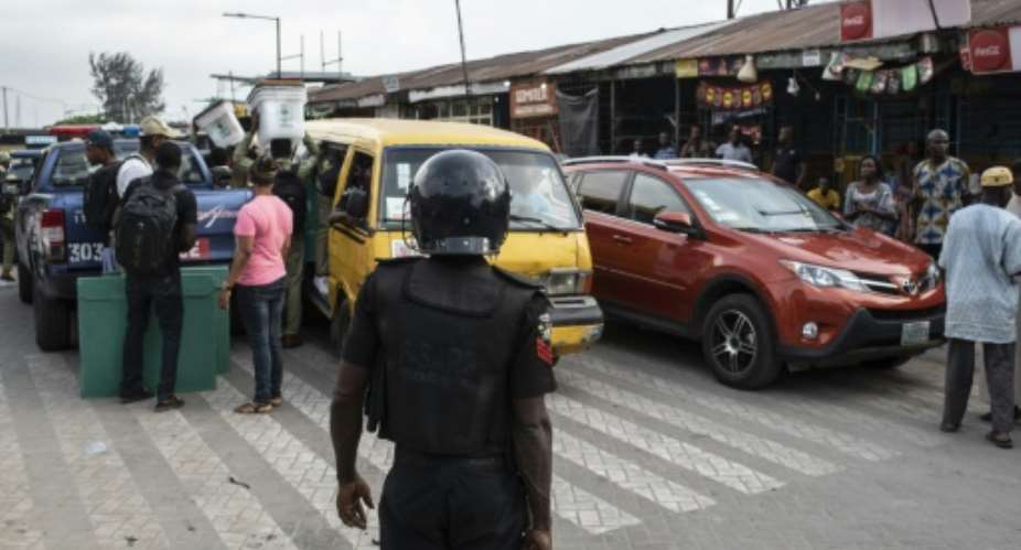 In Lagos, vehicles expected to distribute ballots and staff failed to arrive on time.  By STEFAN HEUNIS AFP