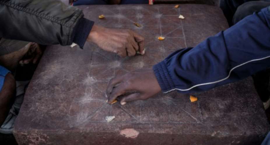 In Madagascar, men sit for hours playing fanorona -- a cross between chequers and chess.  By RIJASOLO AFP