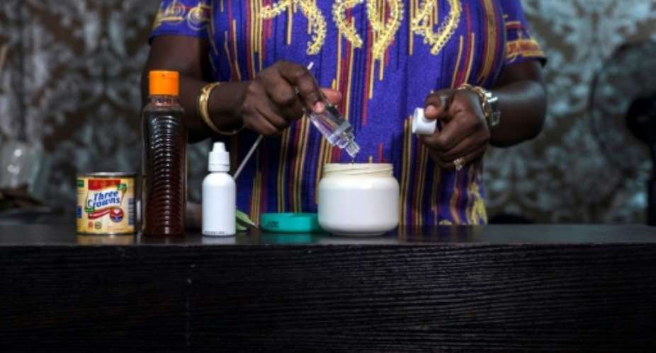In many countries, skin lightening cream is mixed in beauty saloons or backstreet shops.  By STEFAN HEUNIS AFP