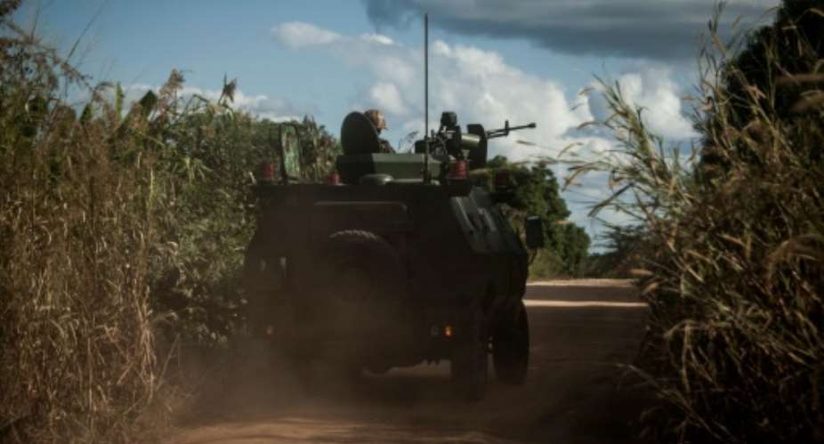 Mozambican regular army vehicles patrol the roads on the outskirts of Vanduzi village in the Gorongosa area.  By John Wessels AFP