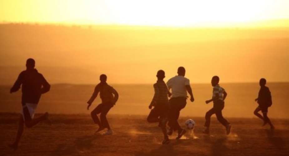 Children from the Eastern Cape village of Qunu play soccer on a makeshift pitch on June 13, 2013.  By Jennifer Bruce (AFP)