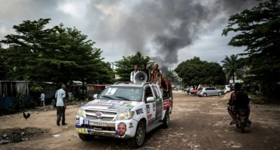 In the early hours of Thursday, arsonists hit a large electoral commission warehouse in central Kinshasa, setting it ablaze and damaging election materials.  By John WESSELS AFP