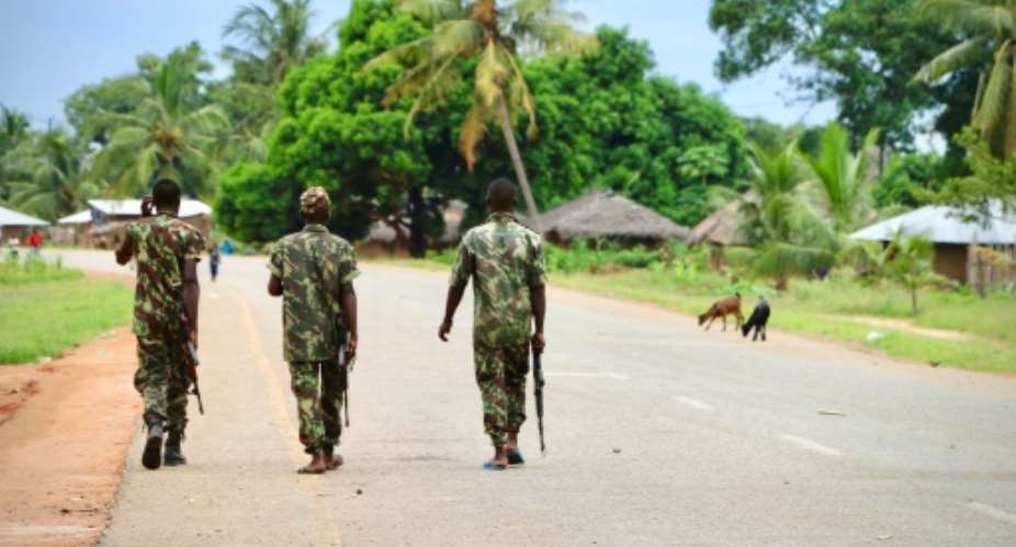 In this file photo taken in March 2018, soldiers from the Mozambican army patrol the streets in Mocimboa da Praia. Three years into a jihadist rebellion, northern Mozambique is still under siege.  By ADRIEN BARBIER AFPFile
