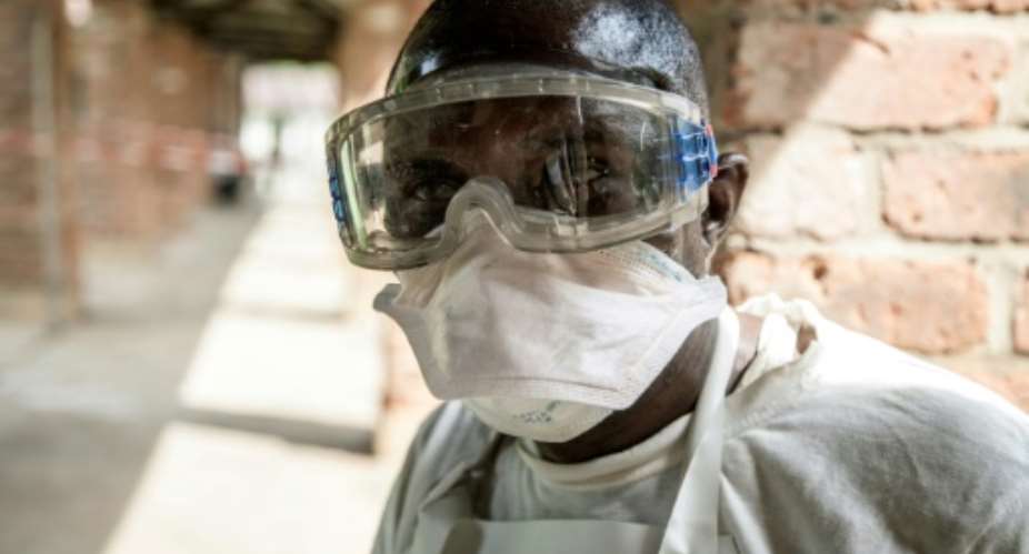 In this handout photograph released by UNICEF on May 13, 2018, a health worker wears protective equipment as he looks on at Bikoro Hospital - the epicenter of the latest Ebola outbreak in the Democratic Republic of Congo.  By MARK NAFTALIN UNICEFAFPFile