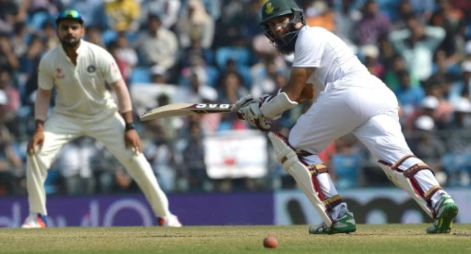 India's captain Virat Kohli L looks on as South Africa's captain Hashim Amla plays a shot on the third day of their third Test match, at The Vidarbha Cricket Association Stadium in Nagpur, on November 27, 2015.  By Indranil Mukherjee AFP