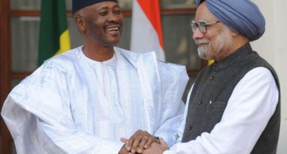 Manmohan Singh  right shakes hand with Amadou Toumani Toure during a delegation level talks in New Delhi.  By Raveendran AFPFile
