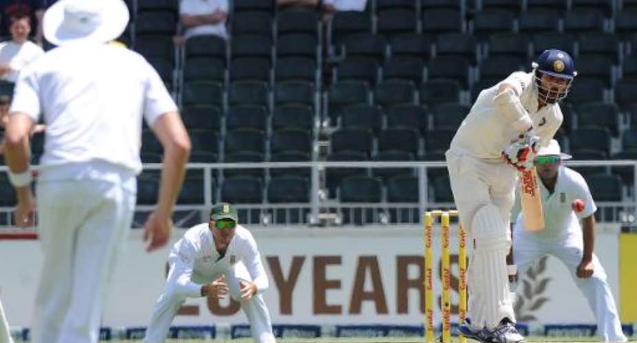 Indian batsman Shikhar Dhawan right plays a shot from South African bowler Venon Philander on the first day of their Test match in Johannesburg at Wanderers stadium on December 18, 2013.  By Str AFP