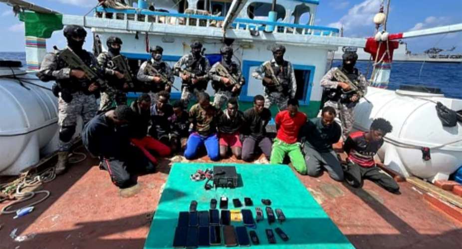 Indian commandos stand guard over Somali pirates who kidnapped an Iranian fishing vessel off the Somali coast,  on January 30.  By - INDIAN NAVYAFPFile