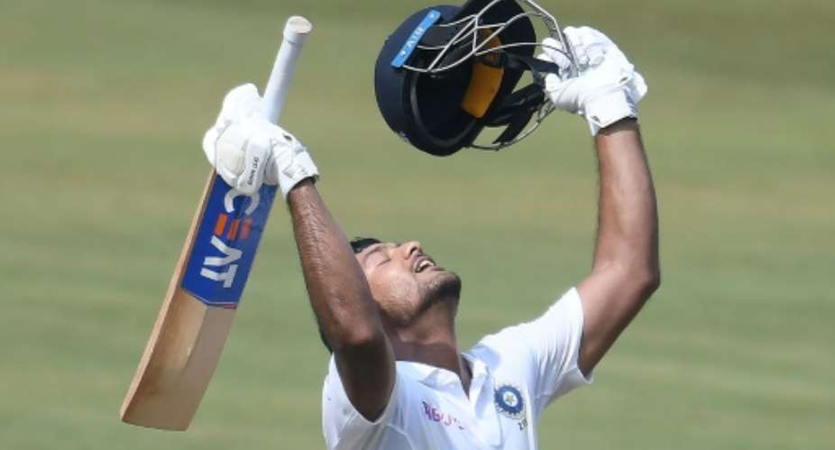 Indian cricketer Mayank Agarwal celebrates scoring 200 runs during the second day's play of the first Test match against South Africa.  By NOAH SEELAM AFP