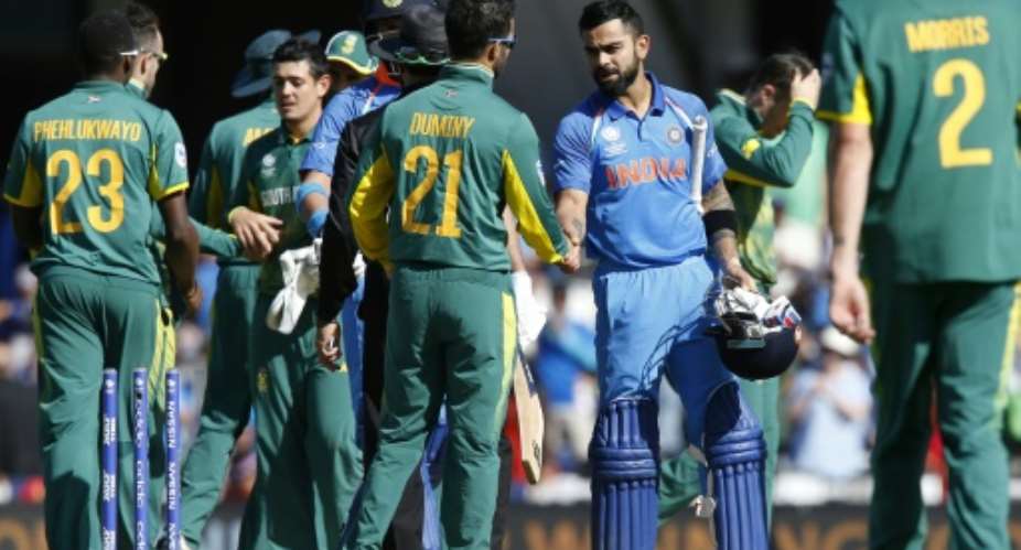 India's captain Virat Kohli C-R shakes hands with South Africa's JP Duminy after their ICC Champions Trophy match, at The Oval in London, on June 11, 2017.  By Ian KINGTON AFP