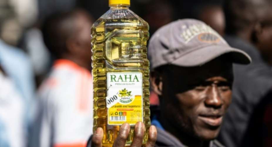 Inflation anger: A protester holds a bottle of cooking oil during a demonstration in Harare last August over the cost of food.  By Zinyange Auntony AFP