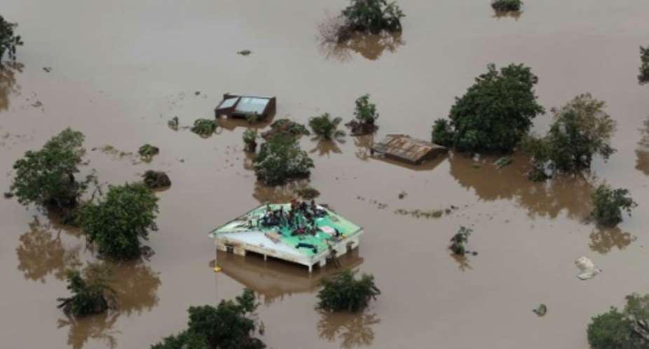 Inland sea: Helicopters are trying to save people stranded on rooftops and in trees.  By Rick Emenaket Mission Aviation FellowshipAFP