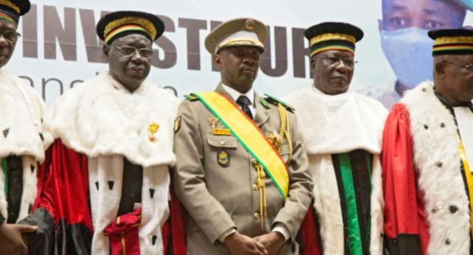 Interim president Colonel Colonel Assimi Goita, centre, stands next to members of Malis Supreme Court at his swearing-in ceremony last June.  By ANNIE RISEMBERG (AFP)