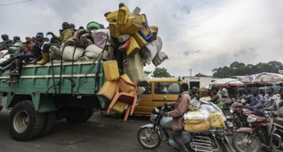 Internally displaced people travel with their belongings on a lorry as they leave camps in Goma, Democratic Republic of Congo, on February 11, 2025.  By Michel Lunanga (AFP)