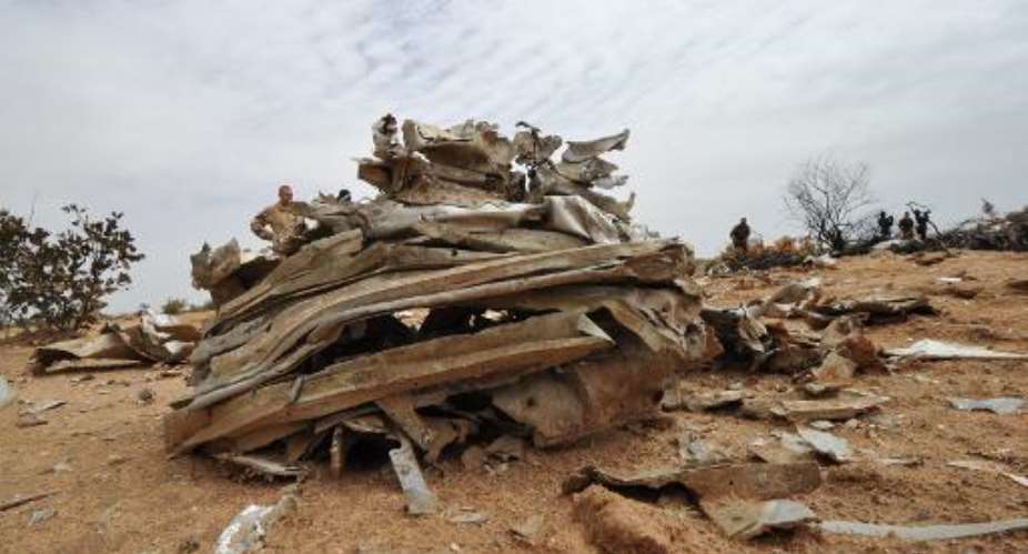 Debris from Air Algerie Flight AH 5017 scattered at the crash site in Mali's Gossi region, west of Gao, on July 26, 2014.  By Sia Kambou AFP