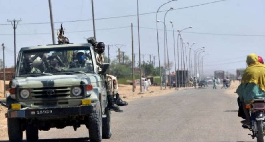 Niger army soldiers patrol not far from Agadez, northern Niger, on September 24, 2010.  By Issouf Sanogo (AFP/File)
