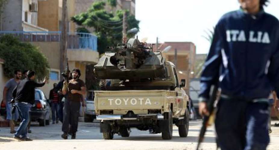 Armed civilians gather in the street during clashes with Islamist militiamen in the al-Lithi area of Libya's eastern coastal city of Benghazi on November 2, 2014.  By Abdullah Doma AFPFile
