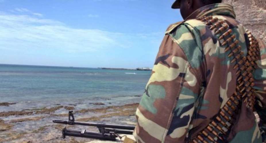A Somalia soldier stands guard in the embattled capital Mogadishu.  By Mohamed Abdiwahab (AFP/File)