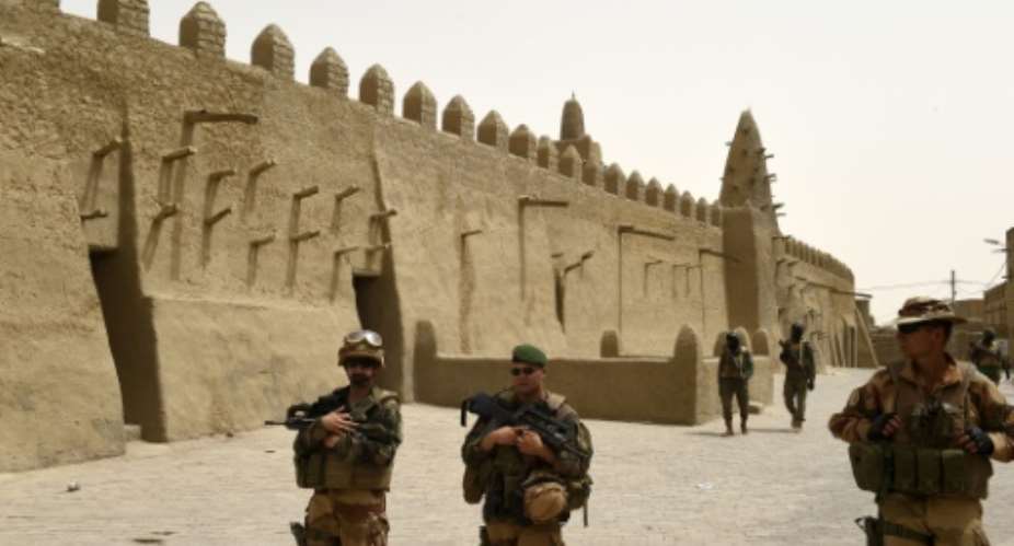 French and Malian soldiers patrol next to the Djingareyber Mosque on June 6, 2015 in Timbuktu, during a joint operation.  By Philippe Desmazes AFPFile