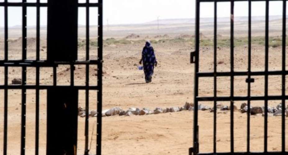 A Sahrawi woman walks in the desert near the Western Sahara refugees camp called 27 February in Tindouf.  By Dominique Faget (AFP/File)
