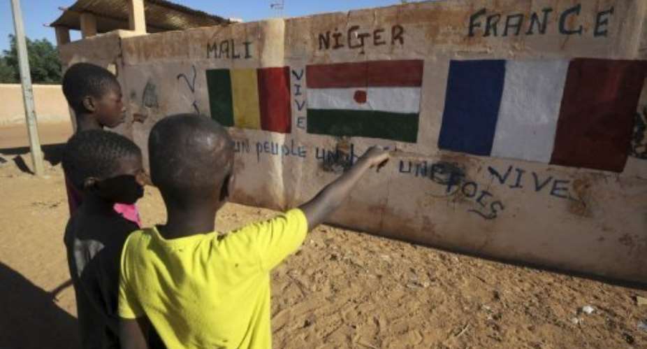 A wall in Gao showing the flags of Mali, Niger and France on February 5, 2013.  By Sia Kambou AFPFile