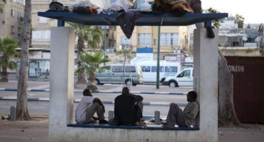 African migrants sit in a bus stop at Tel Aviv's Levinsky Park in May.  By Menahem Kahana AFPFile